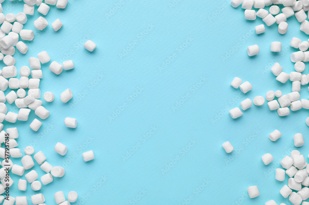 Delicious marshmallows on light blue background, flat lay. Space for text
