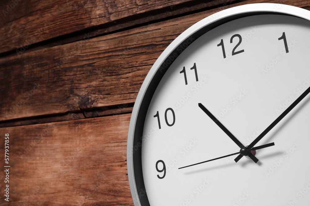 Stylish round clock on wooden table, space for text. Interior element Stylish round clock on wooden table, space for text. Interior element