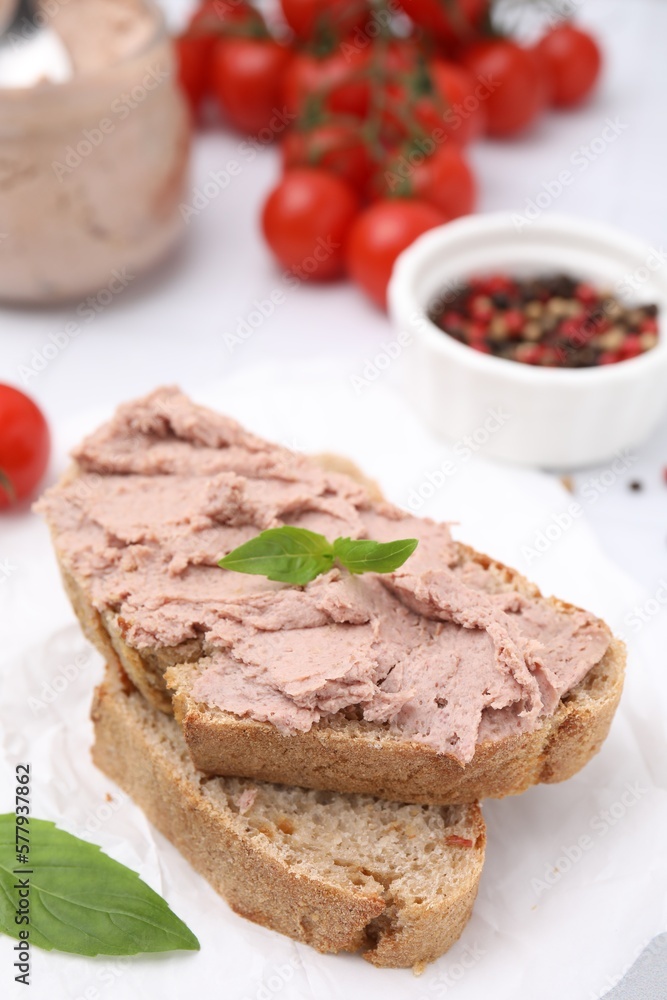 Delicious liverwurst sandwich with basil on white table Delicious liverwurst sandwich with basil on white table