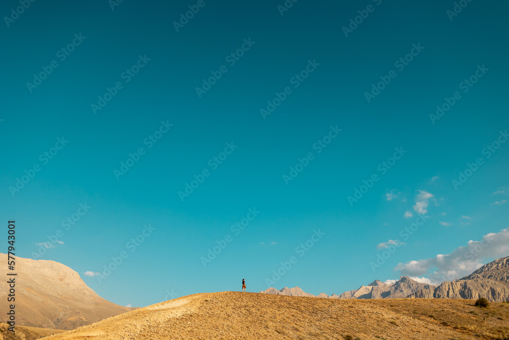 Hiking in the mountains. The girl is walking along a mountain path.