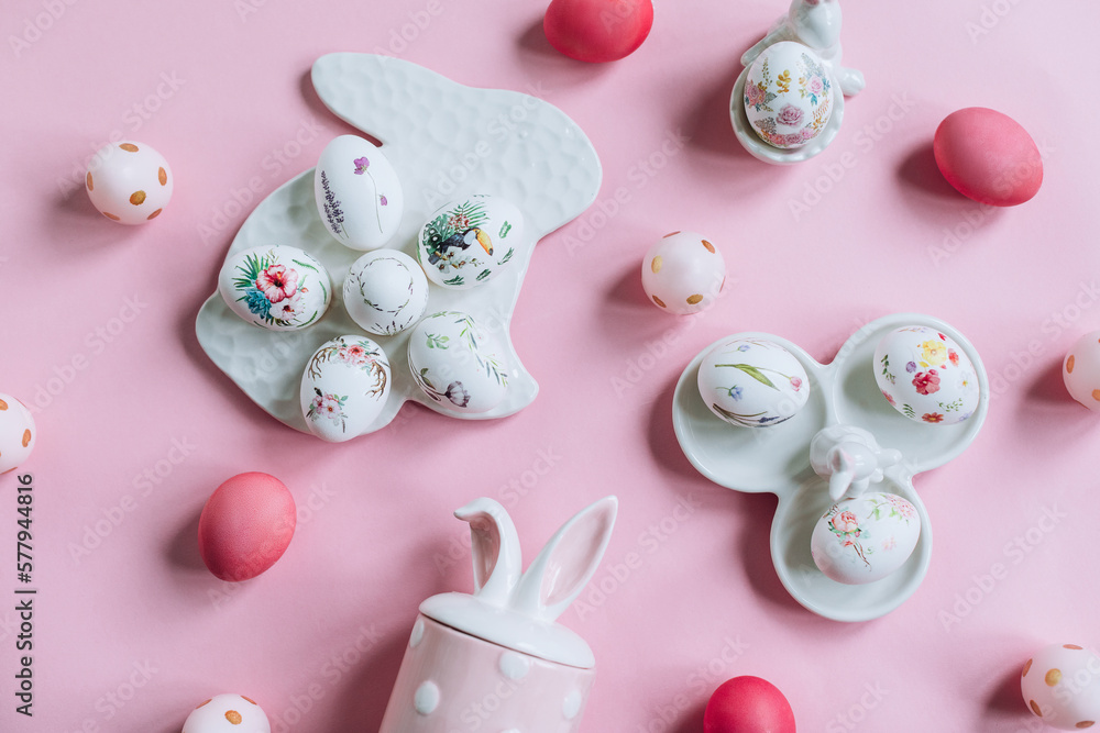 Easter composition with painted pink eggs and decorative figures with rabbits Easter composition with painted pink eggs and decorative figures with rabbits