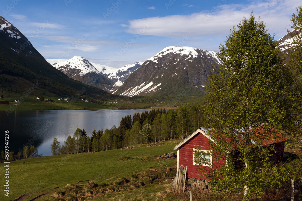 Idyllic fjord scenery wit snow covered mountains in Norway.	