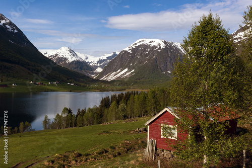 Idyllic fjord scenery wit snow covered mountains in Norway. 