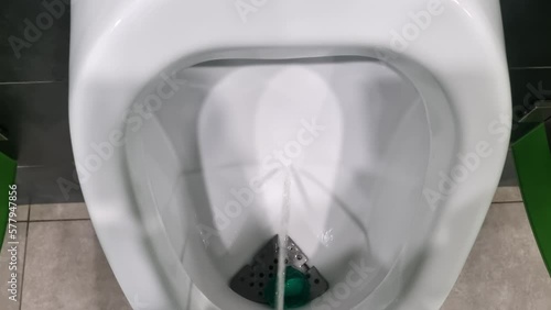 a stream of urine in a toilet bowl. a man pees in the toilet. photo