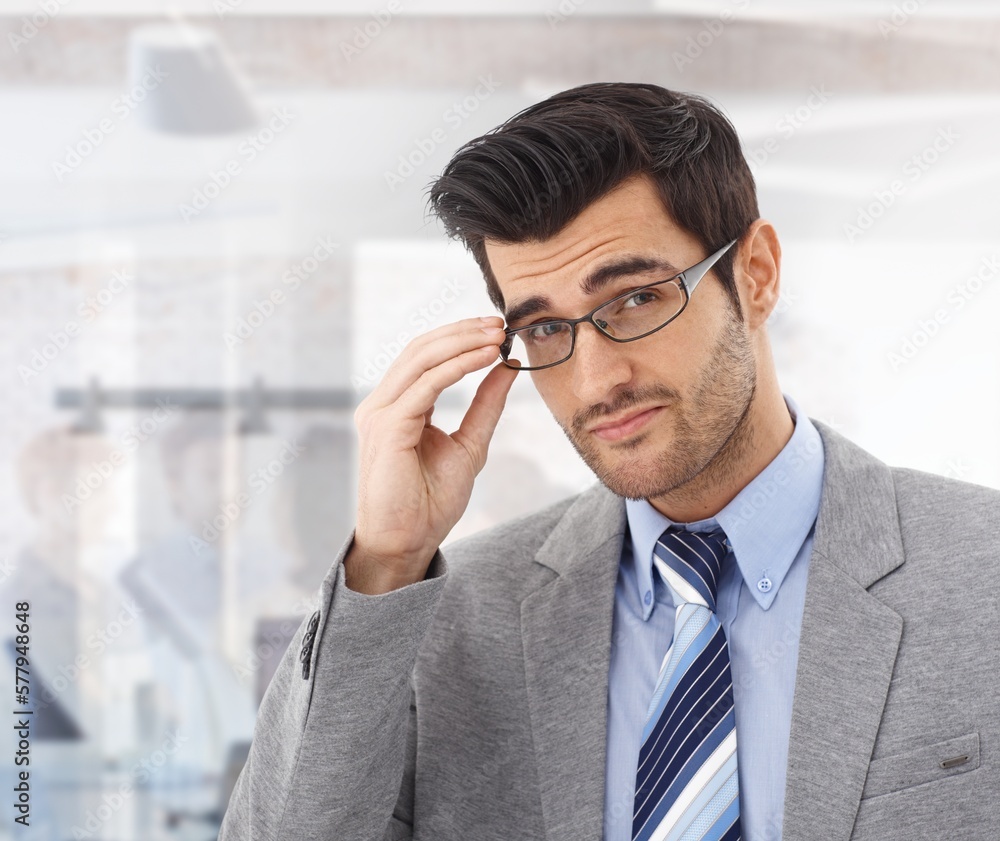 Portrait of young handsome businessman in glasses, looking at camera. Portrait of young handsome businessman in glasses, looking at camera.
