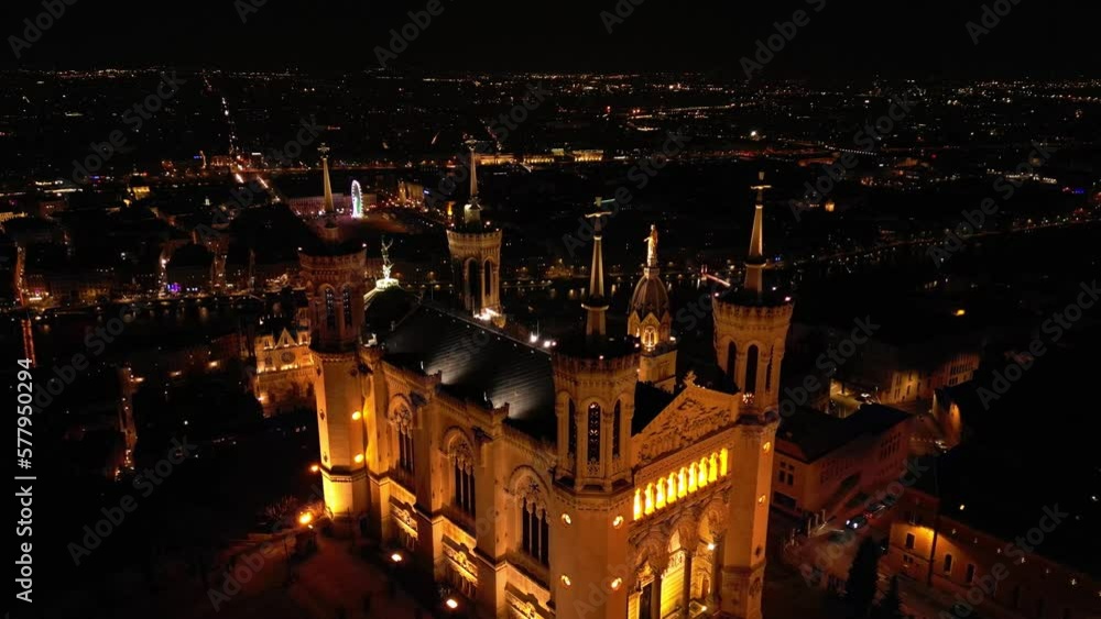 Panoramic aerial shot at night time of illuminated Basilica Notre Dame de Fourviere 