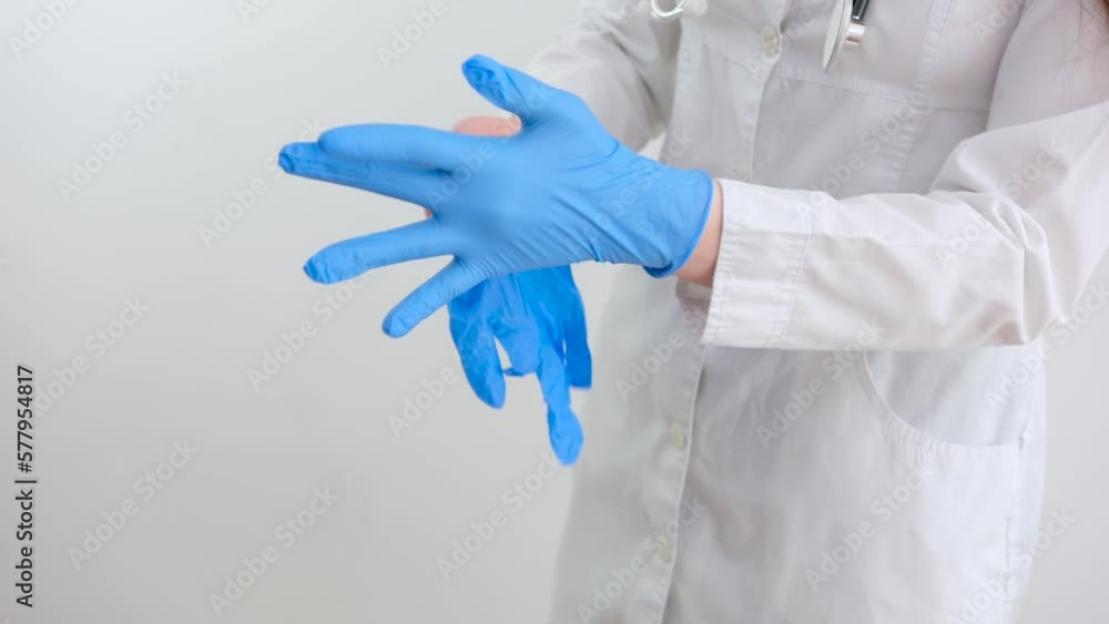 Two blue surgical medical gloves, insulated on a white background with hands. Producing rubber