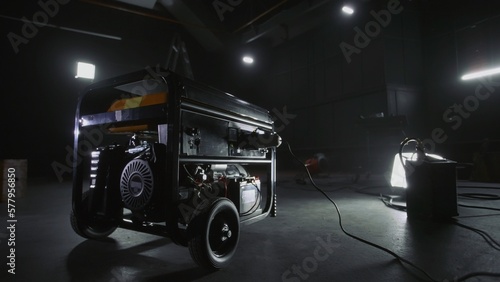 Foto Black mobile gasoline power generator in a dark workshop