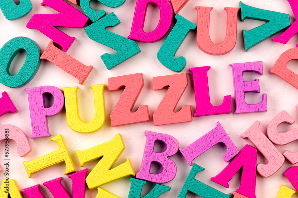 Obraz premium Inscription puzzle made of wooden letters on a white background. Children's creativity.