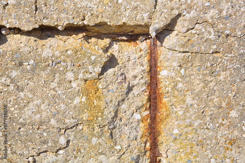 Old reinforced concrete wall without concrete cover due oxidation with damaged and rusty metallic reinforcement