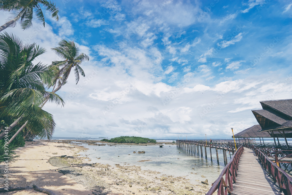 Beautiful landscape. Sunny day on seashore. Wooden bridge on Cloud 9 beach, Siargao Island Philippines.