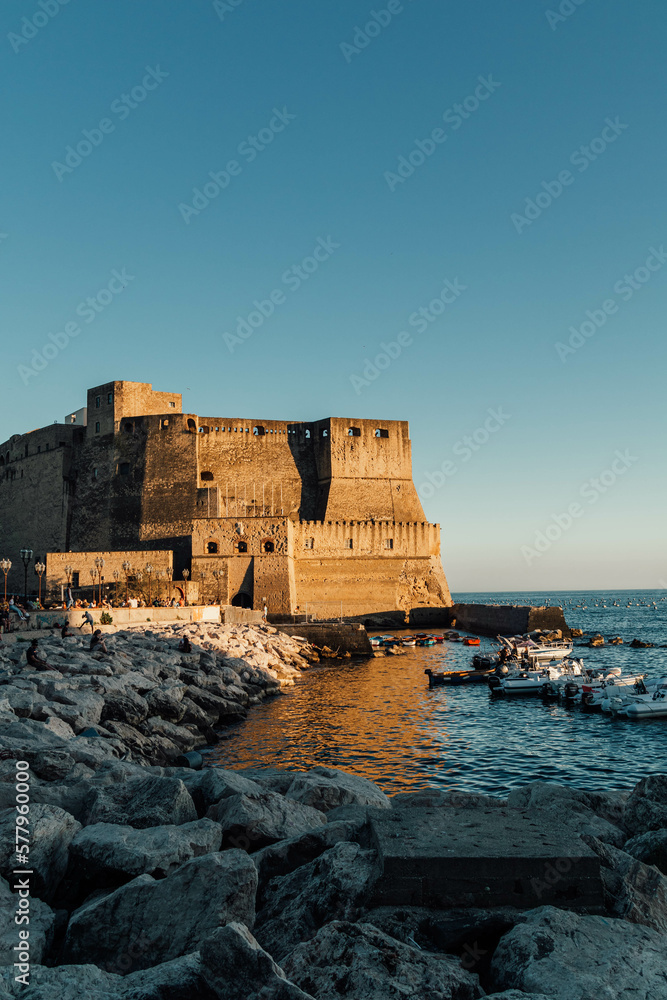 Castel dell'Ovo - Ovo Castle Naples, Italy - Romanesque architecture in Naples dating back to the Norman period - ancient castle in italy in the sea, vertical photo