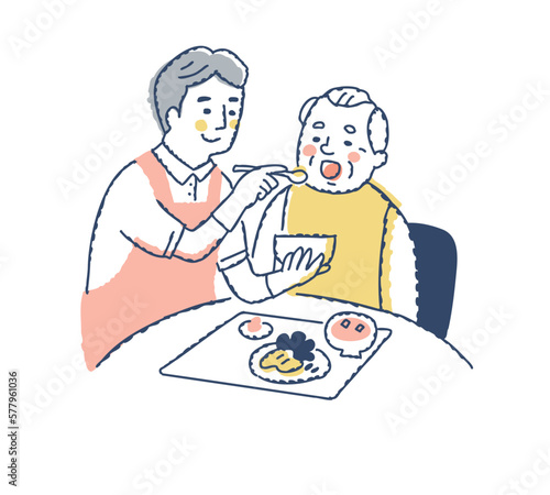 シニア男性の食事介助をしている介護スタッフ