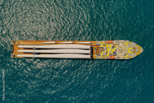 Heavy load carrier ship loaded with Electric Turbine Blades anchored at Sea, Aerial view