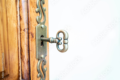 Close up of old key in keyhole, macro shot. Retro style with white background. Write Your Text Here.