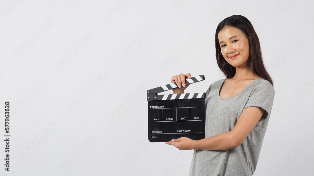 Black clapper board or movie clapperboard in hand of asian woman on white background. Black clapper board or movie clapperboard in hand of asian woman on white background.