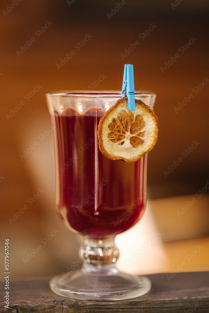 Red tea in a heat-resistant glass with a slice of dried orange Red tea in a heat-resistant glass with a slice of dried orange