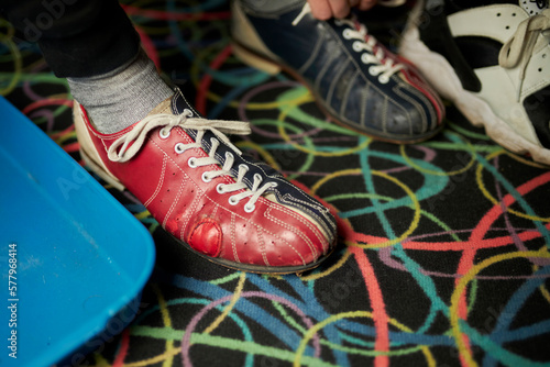 bowling shoes. Young man lacing his shoes in bowling club. closeup