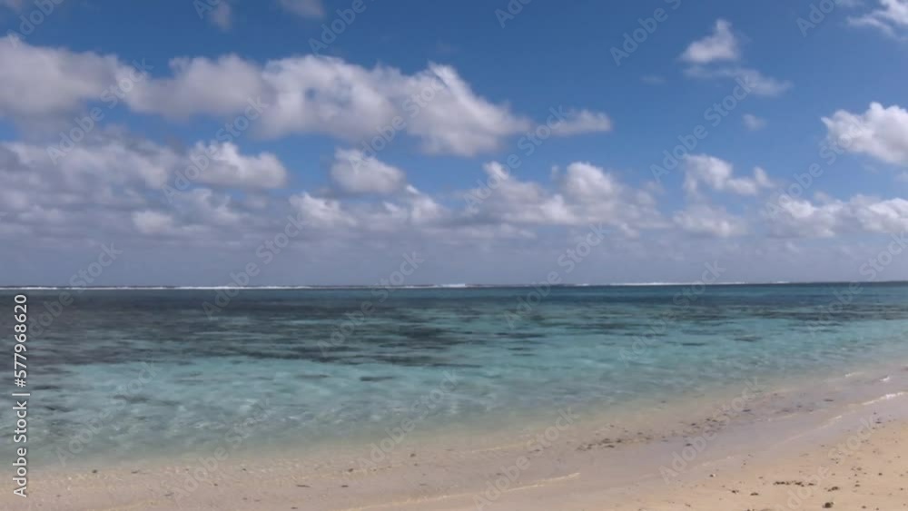 horizontal view right to left of look out from Avaavaroa Cook Islands to south pacific ocean within lagoon with calm sea turquoise blue water during day sunshine cloud cast on sandy beach horizontal view right to left of look out from Avaavaroa Cook Islands to south pacific ocean within lagoon with calm sea turquoise blue water during day sunshine cloud cast on sandy beach