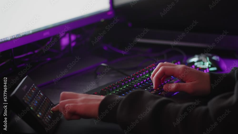 Male hands is typing on the computer keyboard, close up view. Fast typing on the black gaming keyboard. Fingers typing on the led rgb keyboard in the dark room. Cinematic 4k footage in real time. Male hands is typing on the computer keyboard, close up view. Fast typing on the black gaming keyboard. Fingers typing on the led rgb keyboard in the dark room. Cinematic 4k footage in real time.