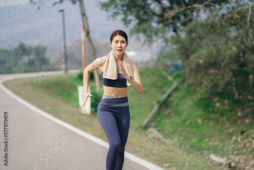 Asian women sprinting outdoors - Sportive people training, healthy lifestyle and sport concepts.
