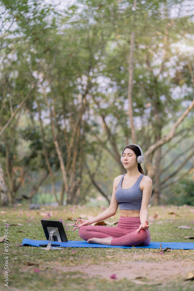 Young woman asian practicing breathing exercise at Park near the house. Young woman asian practicing breathing exercise at Park near the house.