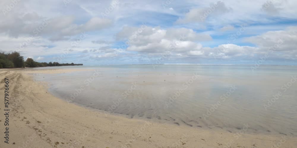 hand hold still view look out from Cook Islands Rarotonga to south pacific within lagoon with calm sea turquoise blue water during bright noon day sunshine cloud cast on soft powder sandy beach hand hold still view look out from Cook Islands Rarotonga to south pacific within lagoon with calm sea turquoise blue water during bright noon day sunshine cloud cast on soft powder sandy beach
