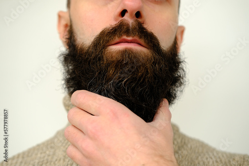 Konstfotografi close-up of part of male face, young bearded man, guy with 30 years strokes his