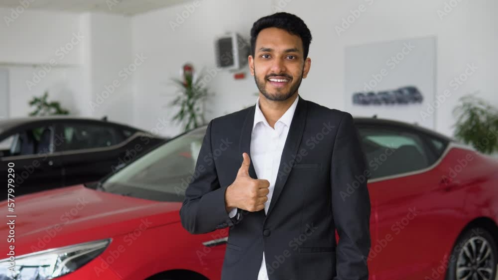 Portrait of a successful indian male manager in a car dealership, car sales Portrait of a successful indian male manager in a car dealership, car sales