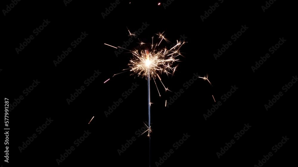 Lightening sparkler on the black background. Sparkler concept. Bengal lights are burning on a black background. Holiday party concept. Newyear party sparkler. Lightening sparkler on the black background. Sparkler concept. Bengal lights are burning on a black background. Holiday party concept. Newyear party sparkler.