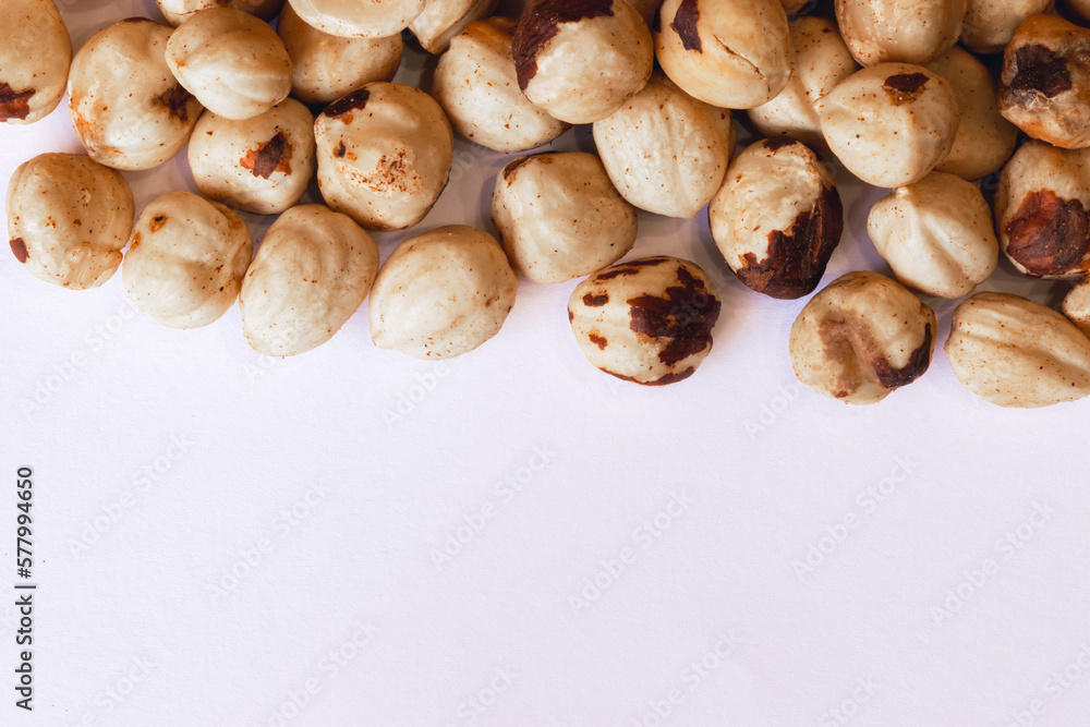 Peeled hazelnuts on a white background. Poorly peeled hazelnuts. Background of peeled hazelnuts.