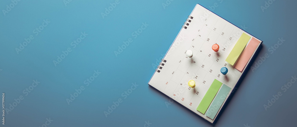 Closeup calendar page with drawing-pins , planning for business meeting or travel planning concept Closeup calendar page with drawing-pins , planning for business meeting or travel planning concept