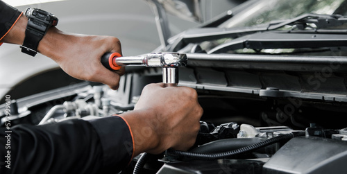 Mechanic fixing a car at home. Repair and service.