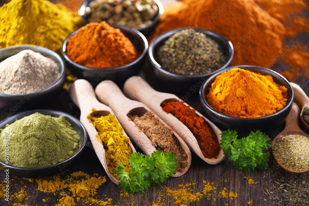 Variety of spices on wooden kitchen table. Variety of spices on wooden kitchen table.