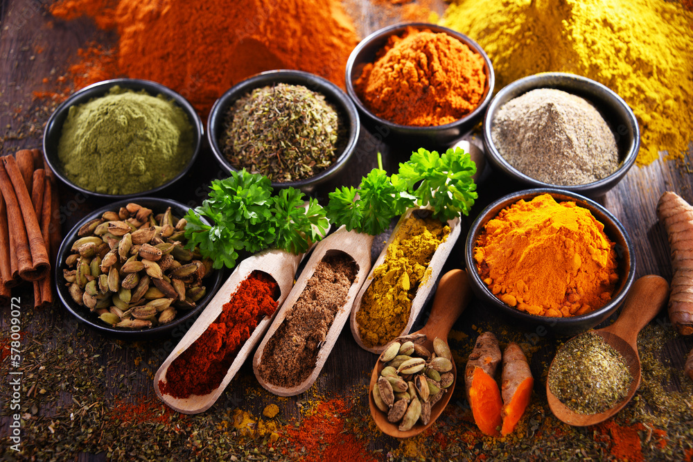 Variety of spices on wooden kitchen table. Variety of spices on wooden kitchen table.