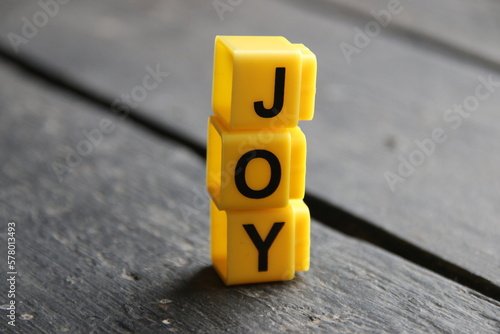 Joy concept, inscription on yellow cubes.