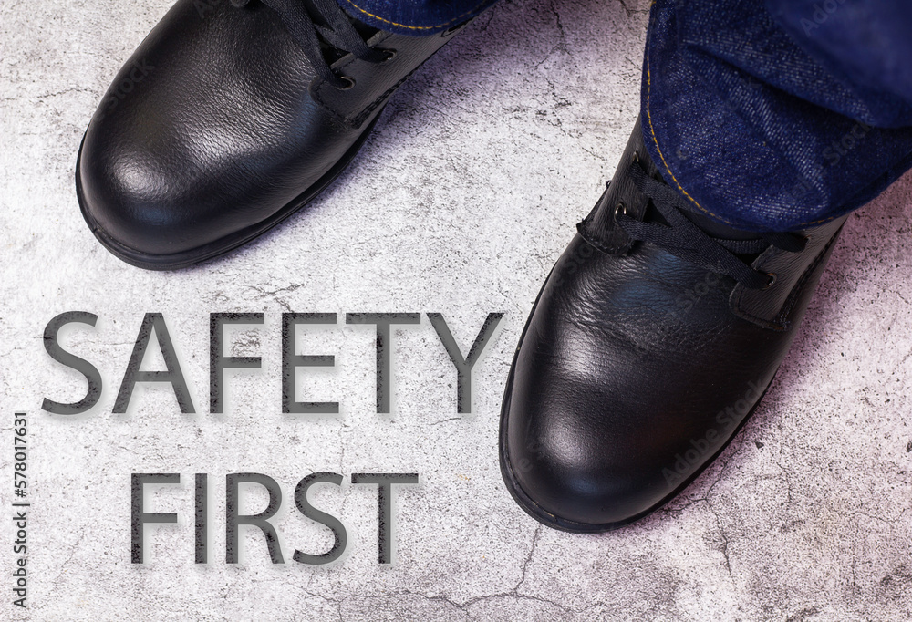 Wear safety shoes to ensure safety at work. construction workers wear
