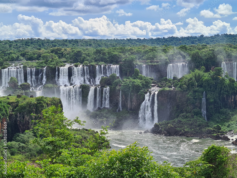 Fototapeta premium Forest surrounding a cascade of waterfalls in foz do iguacu, one of the 7 natural wonders f the world.