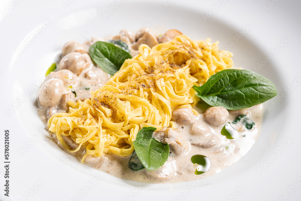 Spaghetti with mushrooms on a white plate. Spaghetti with mushrooms on a white plate.