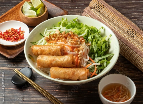 Photography Fried Spring Rolls Cold Rice Vermicelli with sauce served in bowl isolated on ta