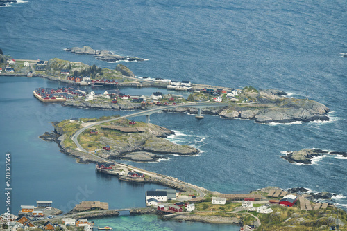 Islets and vehicular flyovers at Reine, Lofoten, Norway, overlooking the lake during a clear spring day with clouds