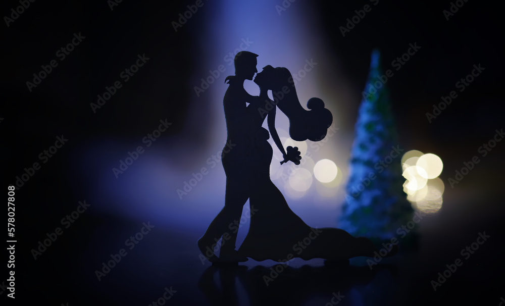 Black silhouettes of pair dancers performing. Man and woman are dancing with white backlight. Choreography. New Year's ball
