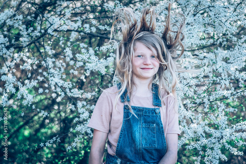 child with long hair in spring nature