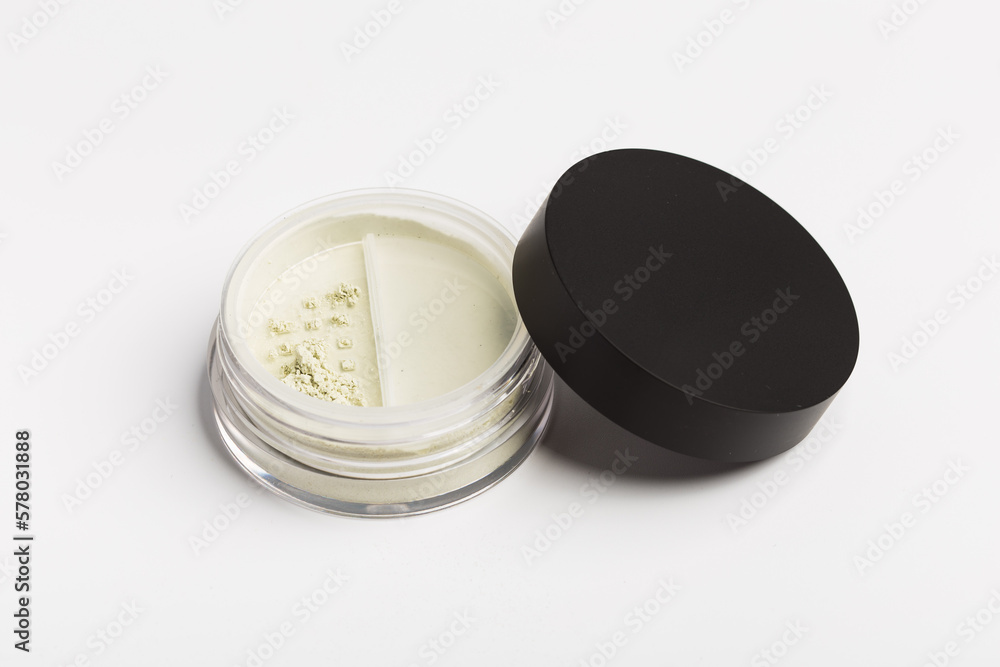 Green cosmetic mineral powder for face on container with twist seal sifter - top view isolated on white background Green cosmetic mineral powder for face on container with twist seal sifter - top view isolated on white background