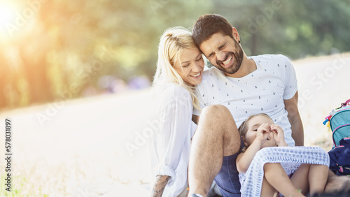 A happy family enjoying nature and having fun with their daughter © Branimir