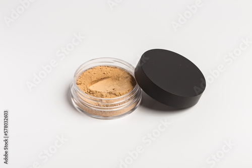 Mineral makeup powder isolated on white background. Light beige foundation powder. Skin tone face cosmetic product sample