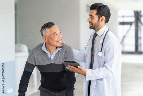 Doctor and patient in medical discussion on digital tablet