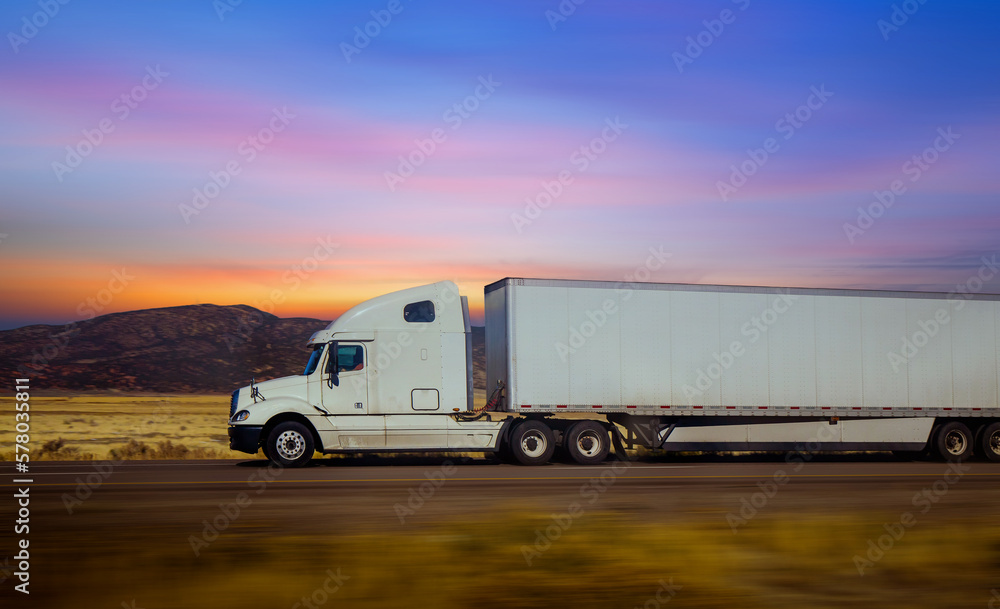 Semi Trucks on the Nevada Highway at twilight sky, USA. Trucking in Utah Semi Trucks on the Nevada Highway at twilight sky, USA. Trucking in Utah