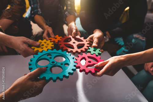 Teamwork of business people work together and combine pieces of gears Fototapet