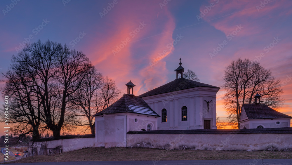 Winter sunset with color sky near Andelska Hora village with ruins and chapel